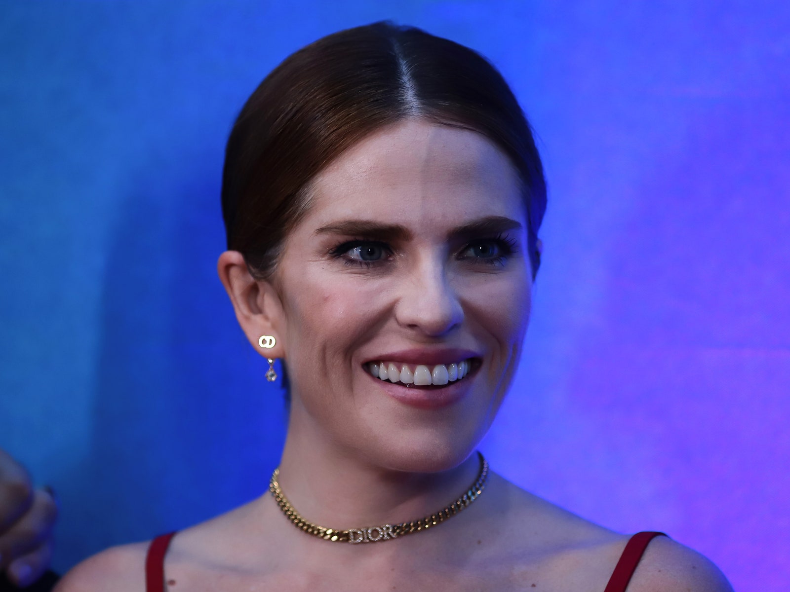Karla Souza smiling at a red carpet event