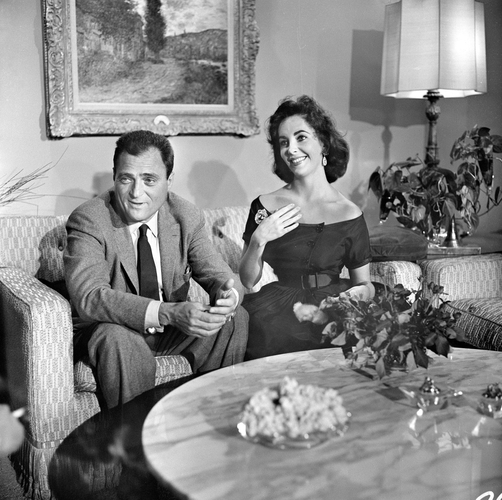 Mike Todd and Elizabeth Taylor sitting on a couch in their home April 5 1957